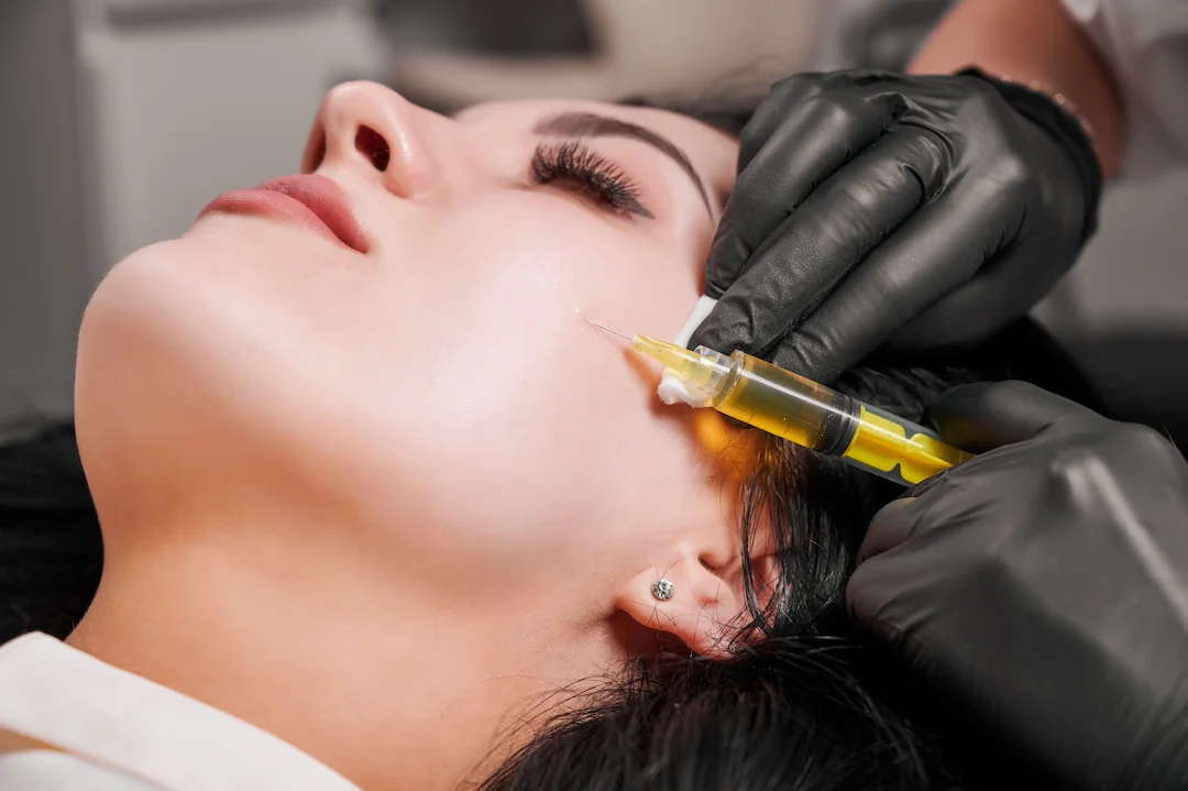 female doctor making injection woman chin 1