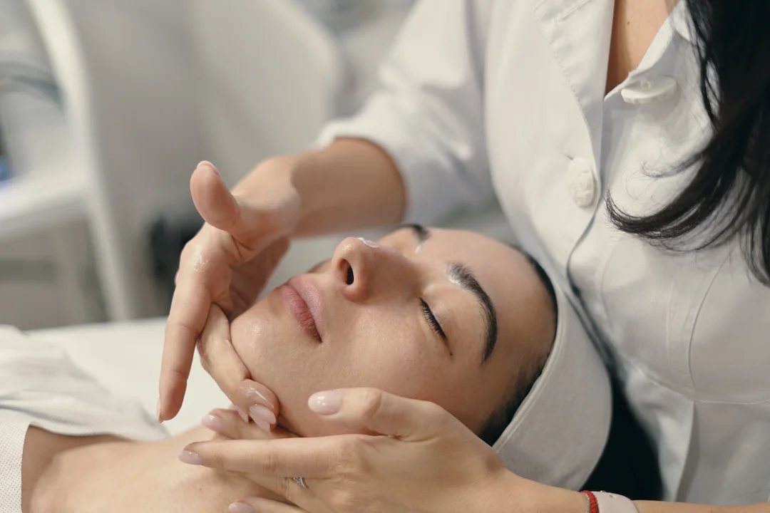 young woman lies with closed eyes cosmetologist making procedure 1